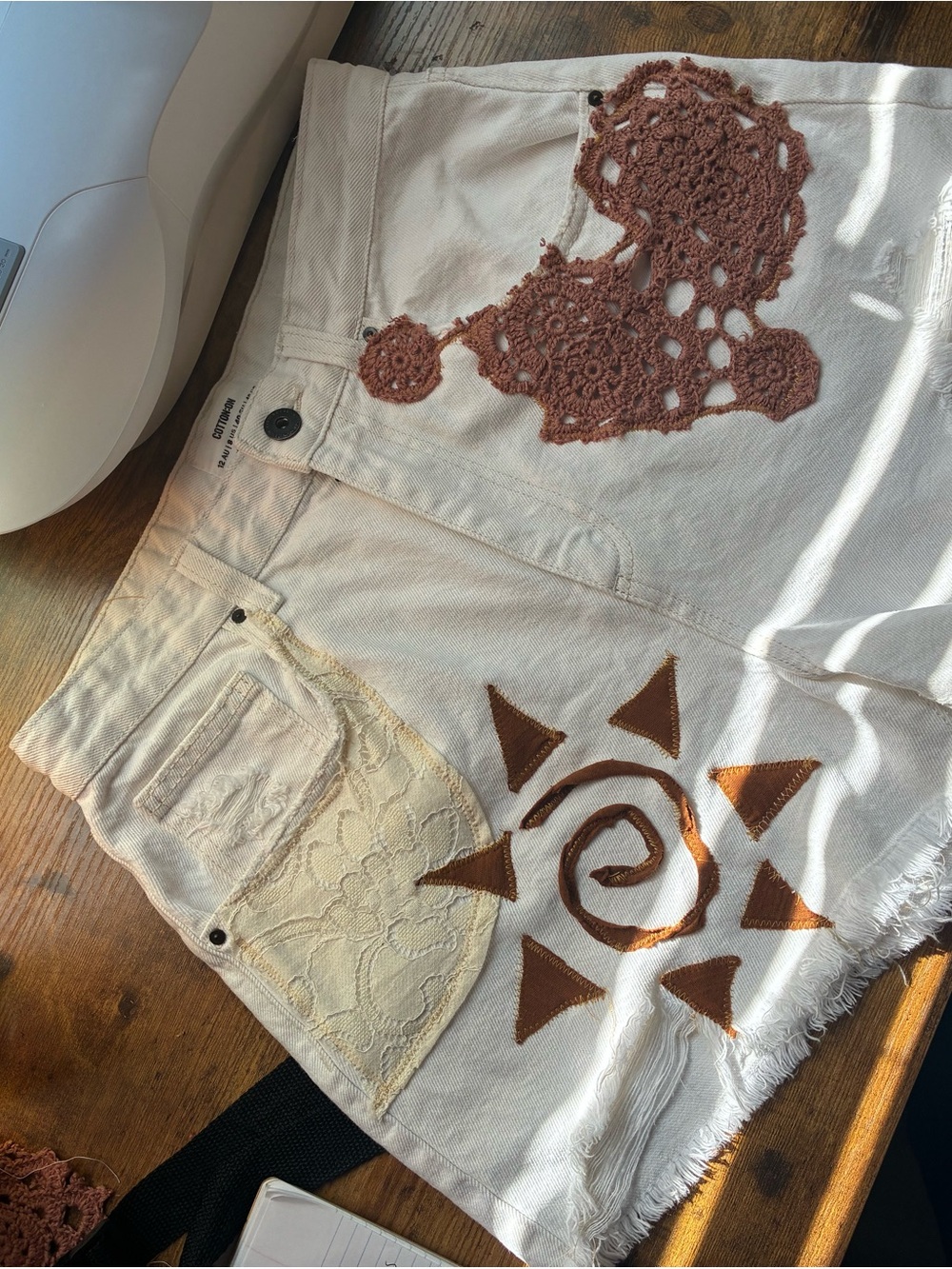 Cream Canvas High Rise Shorts with Brown Crochet & Sun Appliqué